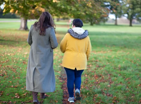 Paula, a therapist at Triskele Counselling, walking with a client in nature, engaging in walk-and-talk therapy.